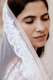Woman wearing a white veil with a blurred background