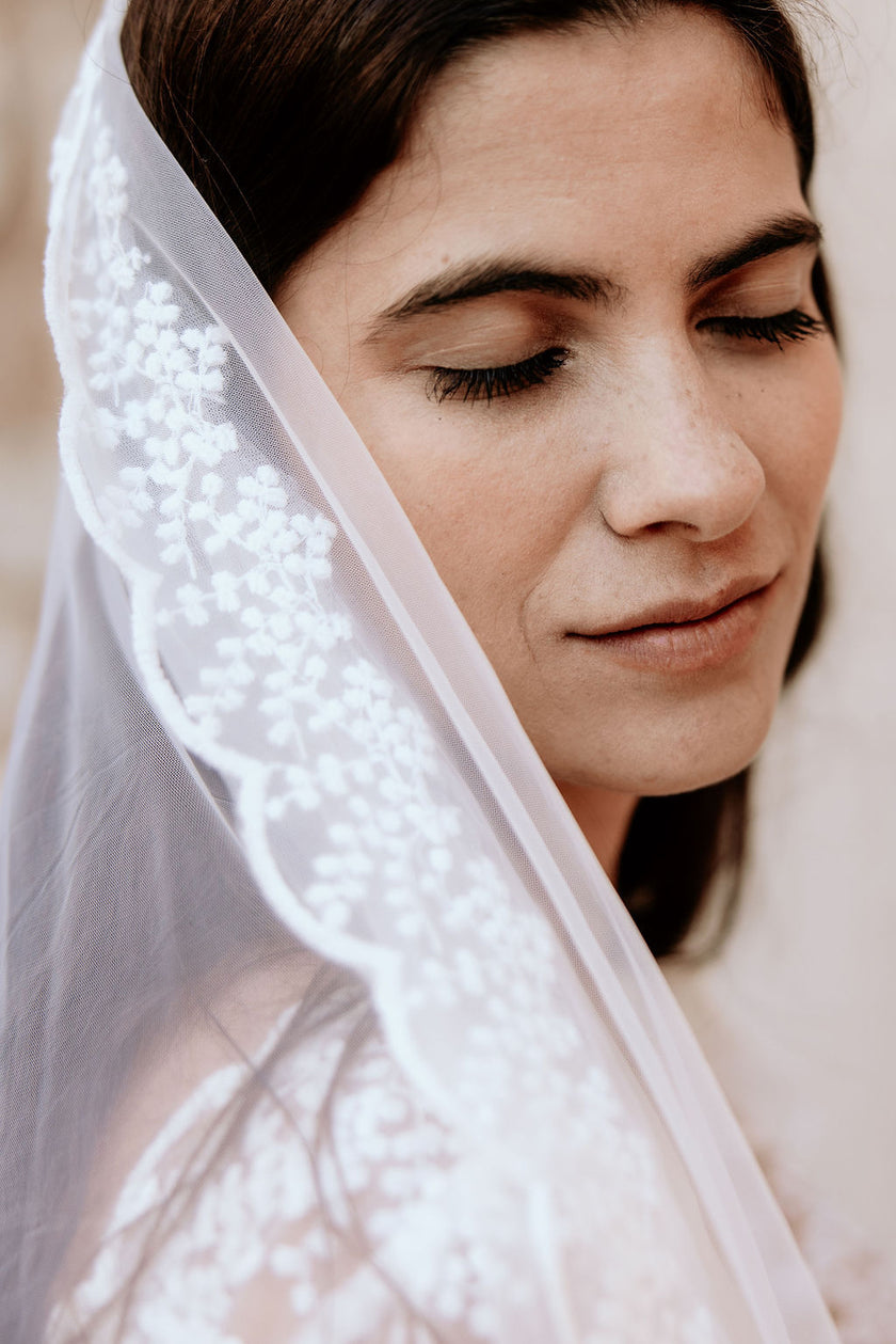 Woman wearing a white veil with a blurred background