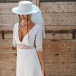 Bride wearing Ariette wedding dress with clean square neckline and structured silhouette, styled for a modern minimalist bridal look indoors
