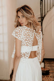 Ariette lace wedding dress with sheer floral back and cap sleeves, featuring open back detail for an elegant modern bridal look