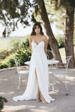 Elegant white strapless wedding dress with sweetheart neckline and front slit, styled outdoors in a serene garden setting, Australia