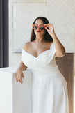 Bride in elegant lace wedding gown posing with soft natural light, showcasing timeless Australian bridal fashion and romantic styling details