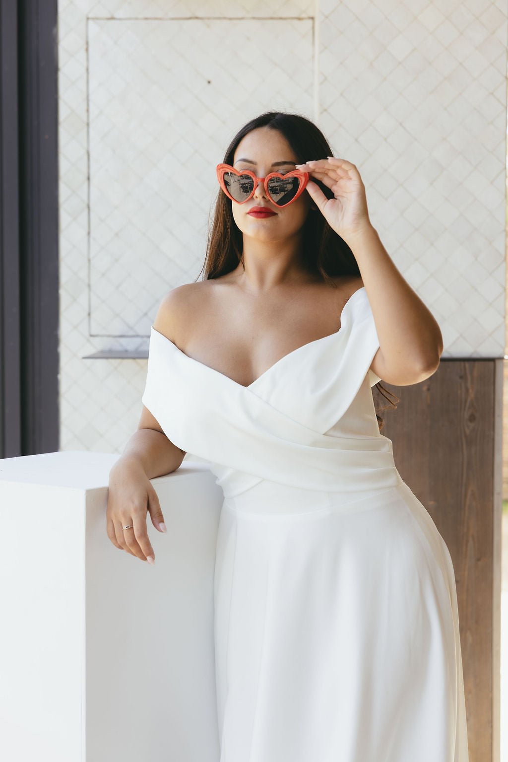 Bride in elegant lace wedding gown posing with soft natural light, showcasing timeless Australian bridal fashion and romantic styling details